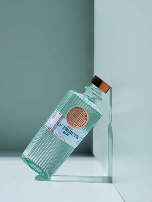 LE Tribute Gin bottle with signature ribbed glass design, creatively positioned against a minimalist mint and white backdrop