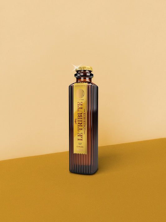 LE Tribute Ginger Beer 200ml bottle, featuring natural ginger flavor and elegant gold label on a warm yellow background