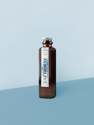 LE Tribute Tonic Water Zero Sugar 200ml bottle, featuring natural quinine and zero sugar on a minimalist blue background