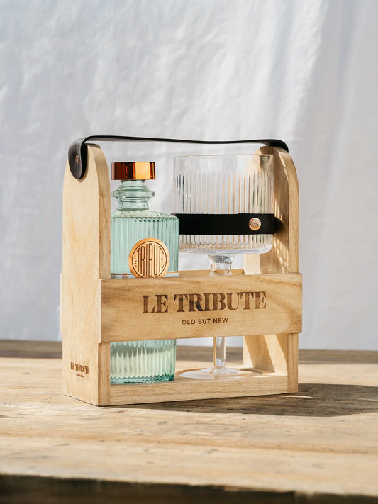 LE Tribute Gin gift set in a wooden carrier, featuring signature ribbed glass bottle and crystal coupe glass with leather accent