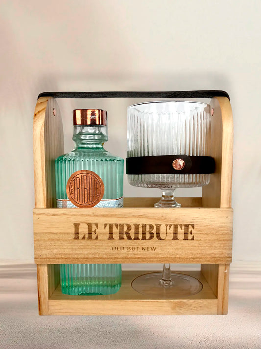 LE Tribute Gin and glass set in a clean wooden presentation caddy, highlighting the brand's signature design