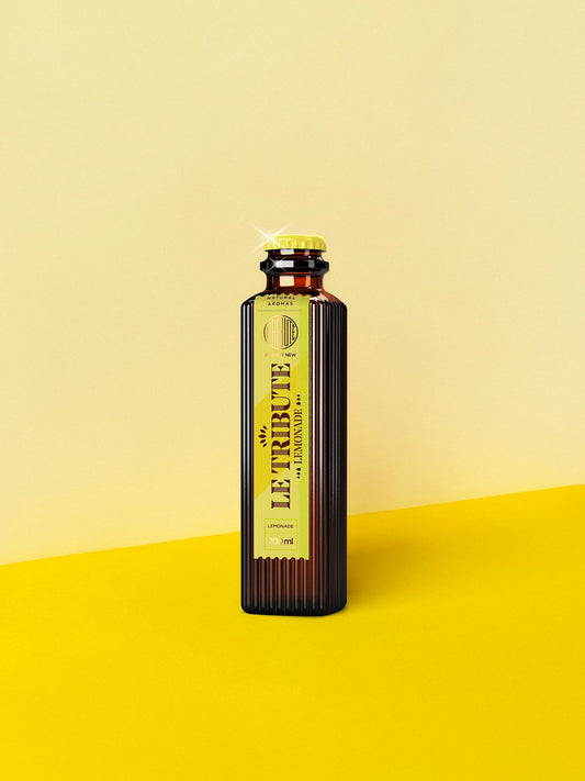 LE Tribute Lemonade 200ml bottle, crafted with natural lemonade juice on a vibrant yellow background