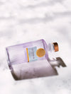 LE Tribute Mezcal bottle from Durango, Mexico, showcased on white marble surface with artistic shadows