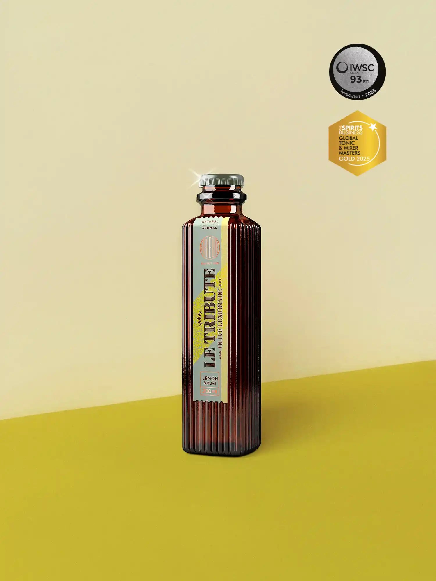 LE Tribute Olive Lemonade 200ml bottle, crafted with natural olive and lemon flavors on a sophisticated beige and yellow background