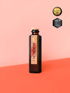 LE Tribute Pink Grapefruit Soda 200ml bottle, crafted with natural pink grapefruit juice on a stylish coral background