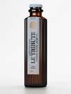 Close-up of LE Tribute Tonic Water Zero Sugar bottle label, highlighting natural quinine and zero sugar benefits